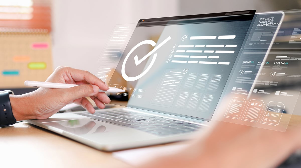 Business professional using laptop with digital checklist and approval dashboard